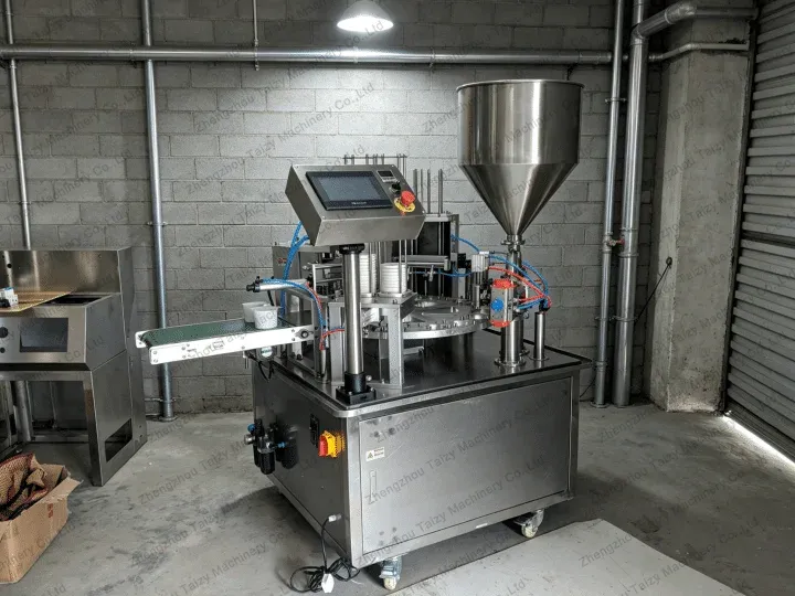 Cup filling and sealing machine